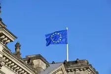 European flag flying with a blue sky behind