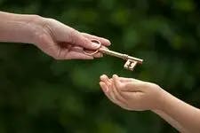 parents starting to save for their kid’s future as early as possible to build them a reliable safety net represented by a picture of an adult passing a golden key on to a child