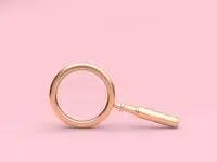 A golden magnifying glass on a pink background