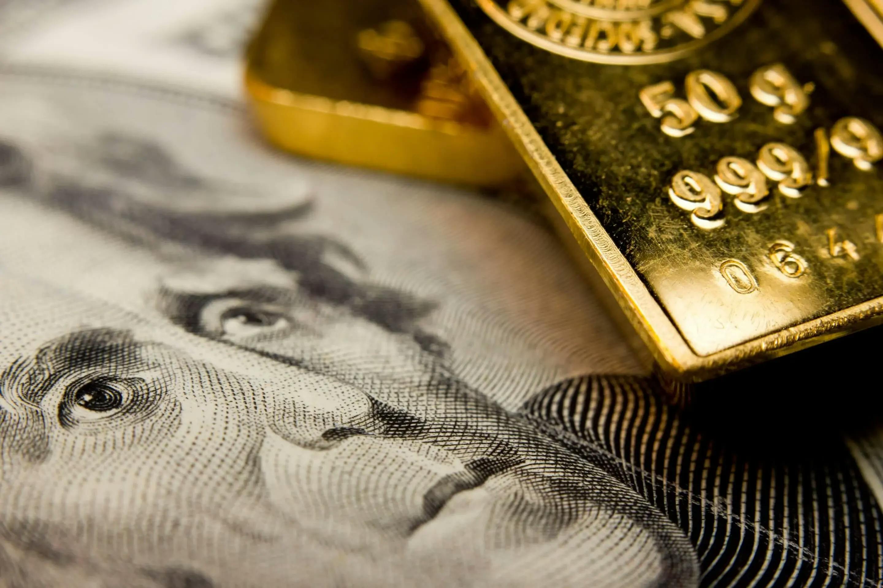 dollar bill and gold bars representing the evolution in monetary systems