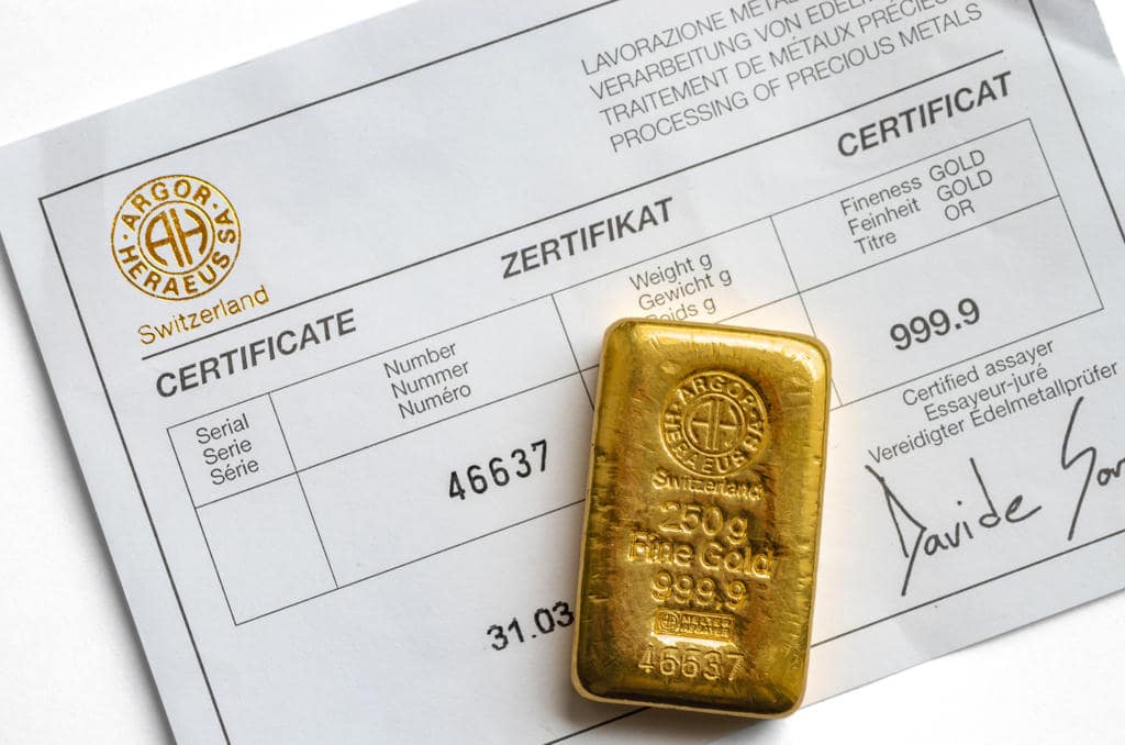 A gold bar on top of its certificate A gold bar on top of its certificate