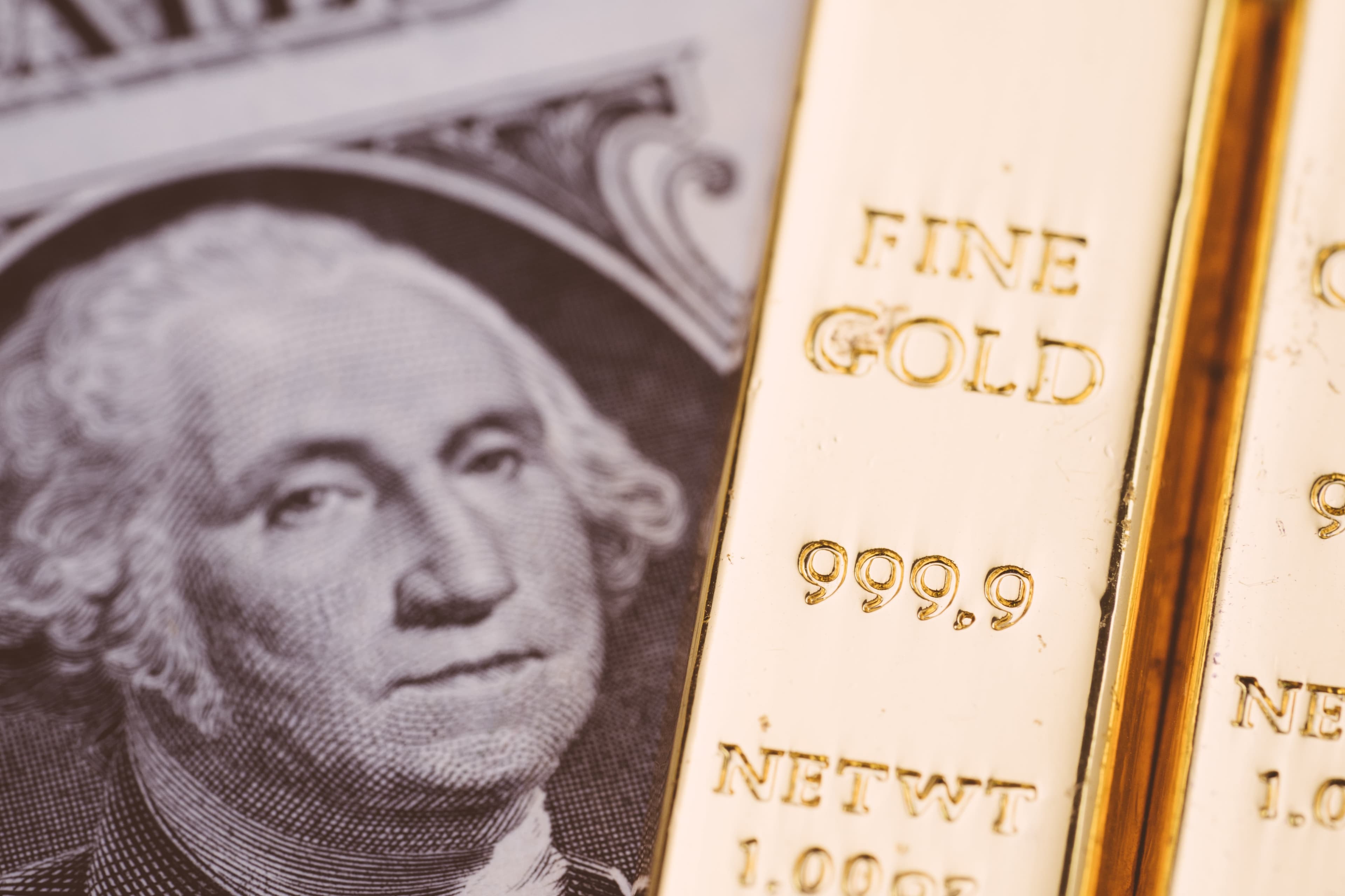 The Gold Standard: Out of Date Economic System or Key to the Future? gold bars on a US dollar bill