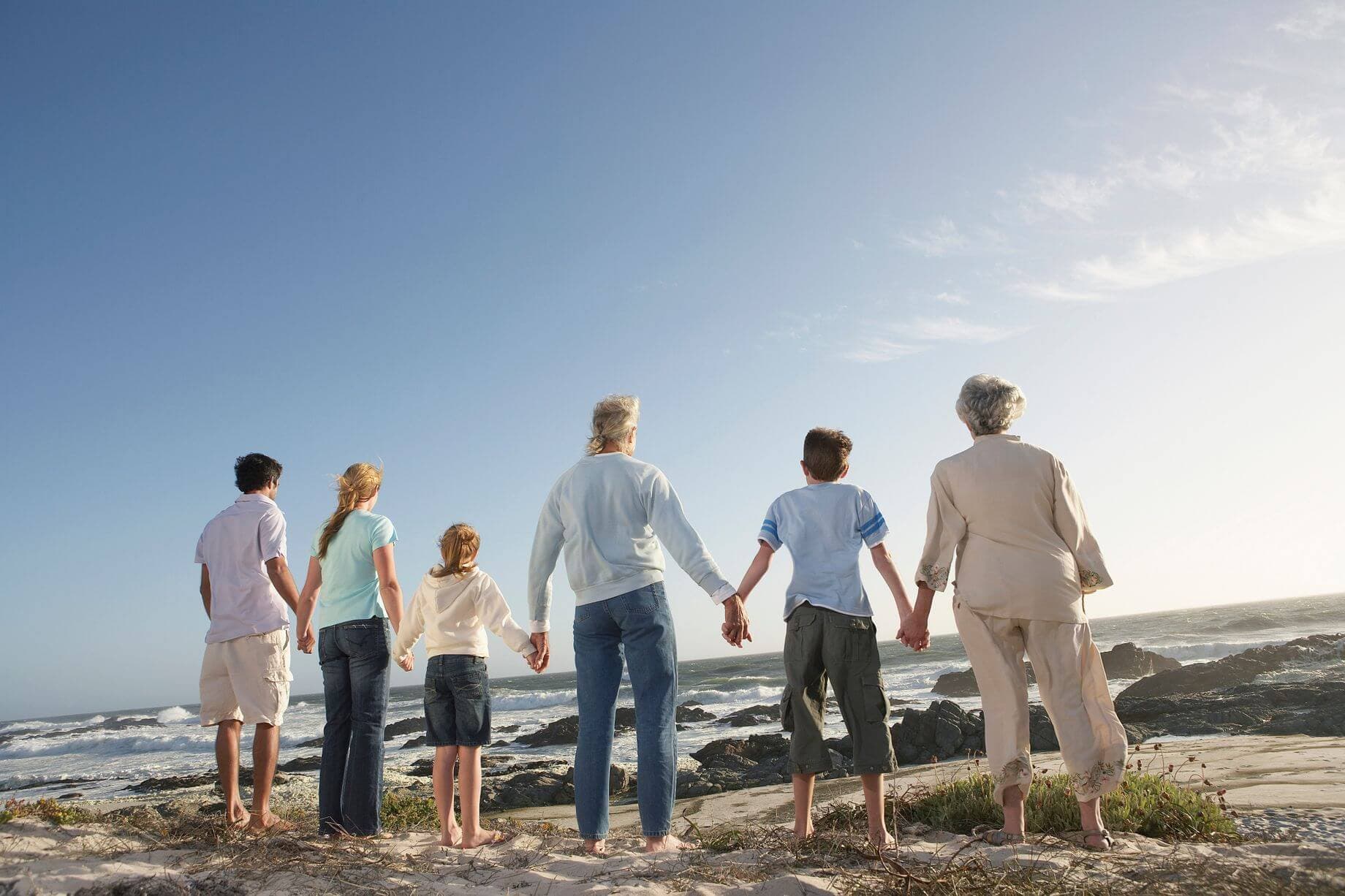 Physical gold as an investment that lasts for generations represented by a picture of a family holding hands and looking at the sea Physical gold as an investment that lasts for generations represented by a picture of a family holding hands and looking at the sea